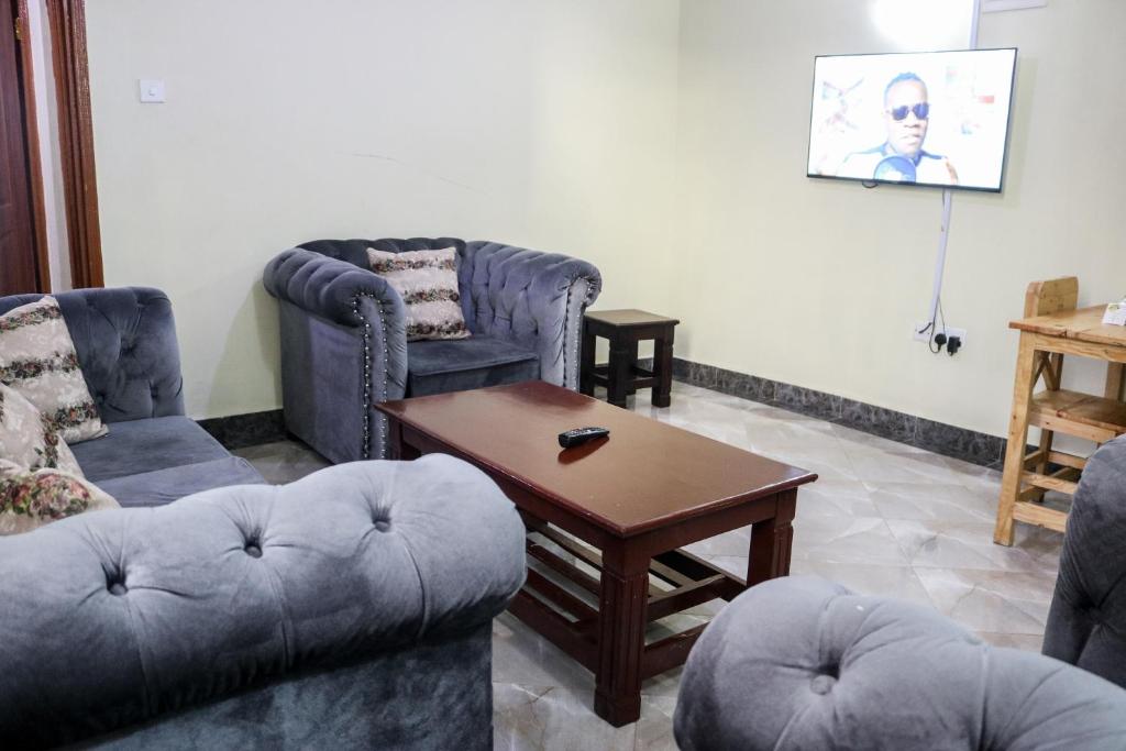 ein Wohnzimmer mit 2 Sofas und einem Couchtisch in der Unterkunft Zedek Furnished Apartment 102 in Nairobi