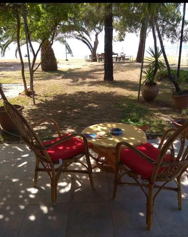 a table and two chairs and a table and a table and chairs at Rent House: Velanidiá in Makryámmos