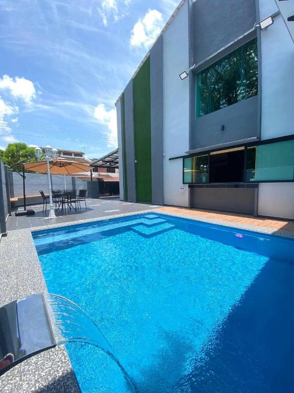 a swimming pool in front of a house at LYL Jaccuzi Private Pool House in Ipoh