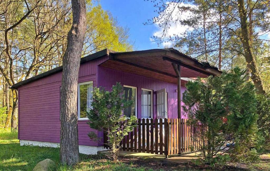 a purple tiny house in the woods at Fh Lila in Warenthin
