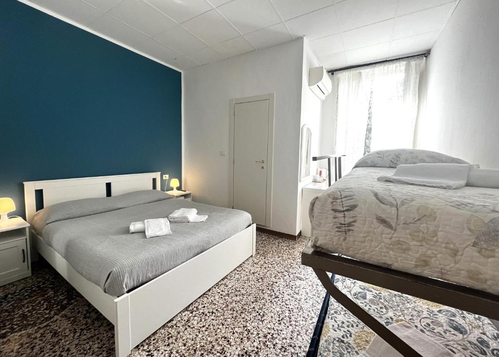 Łóżko lub łóżka w pokoju w obiekcie Hotel Baia di Levanto