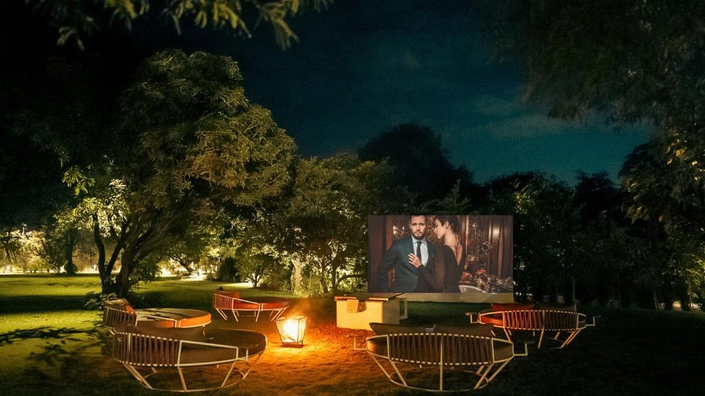 a large screen with a picture of a couple at Giovanni Village Resort in Bhopal