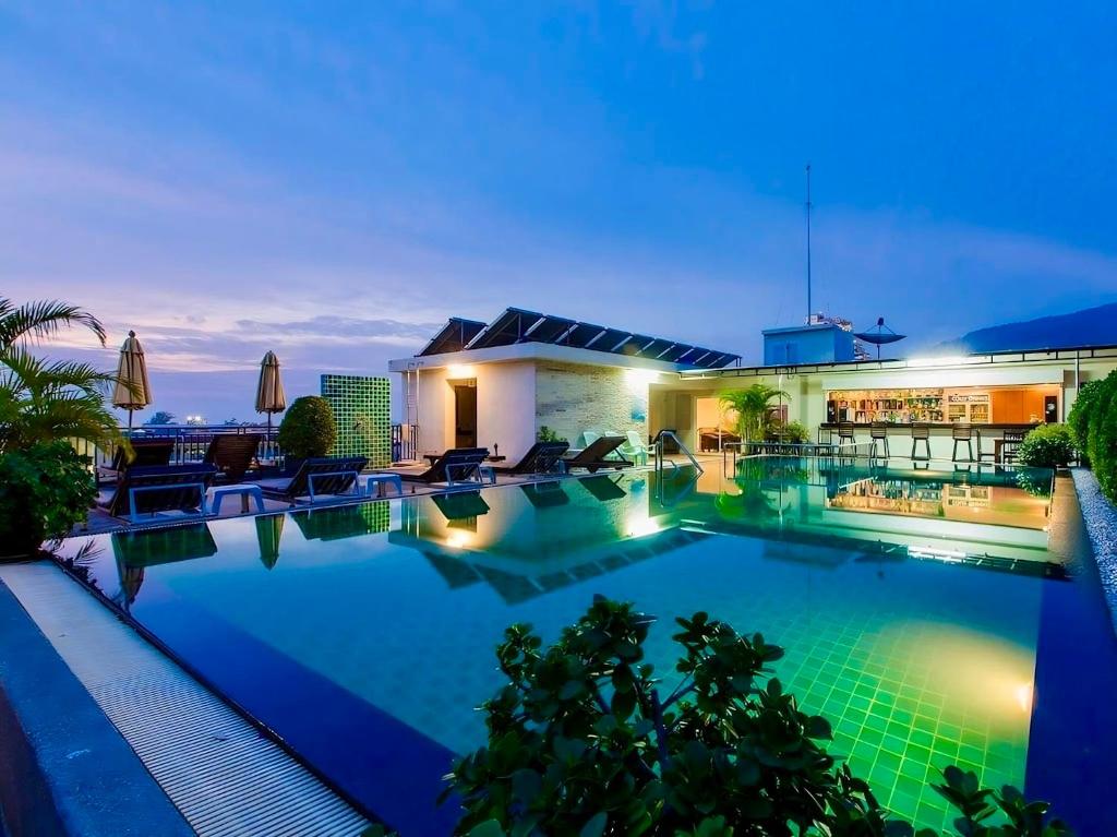 a view of a swimming pool at night at 77 Patong Hotel & Spa in Patong Beach