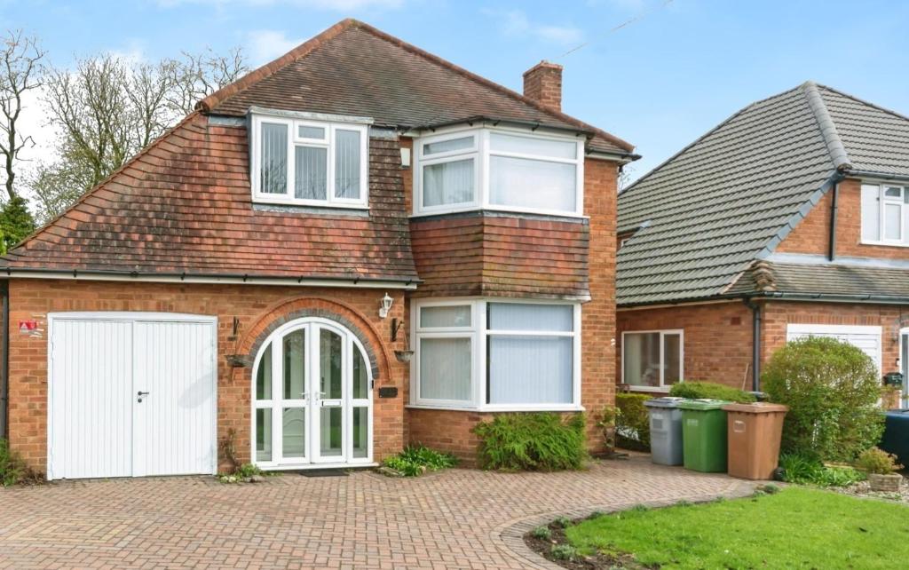 a brick house with a white garage at Modern 3 Bed Home - Solihull Centre in Solihull
