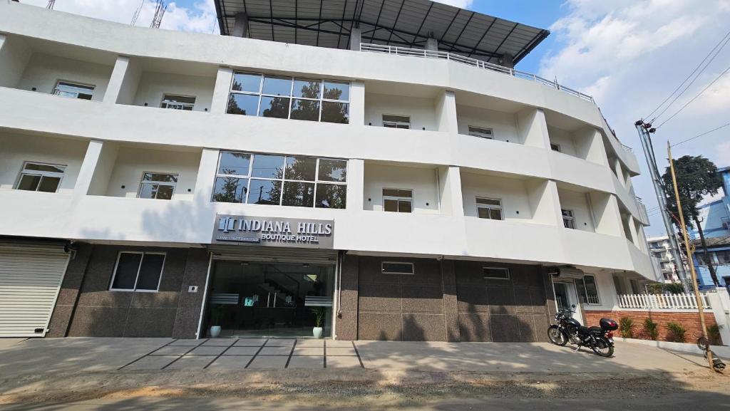 a large white building with a sign on it at INDIANA HILLS in Shillong