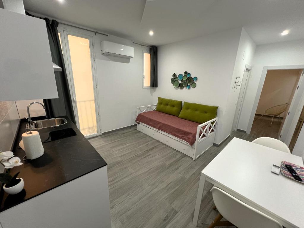 a living room with a couch and a table at Cómodo apartamento Mayor y Sol in Madrid