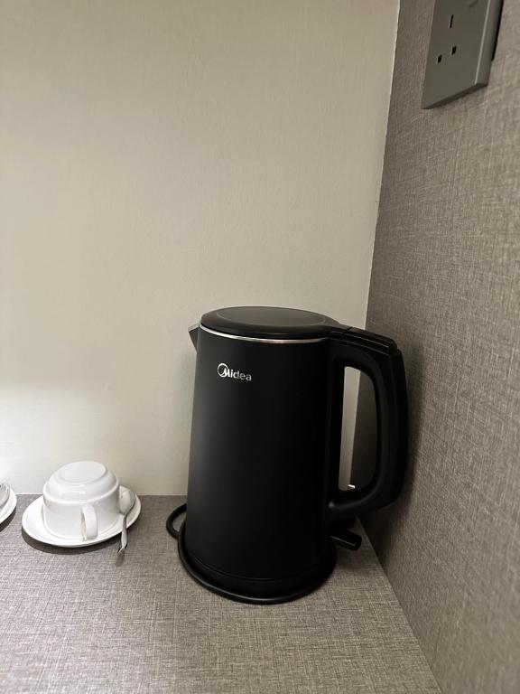 Příslušenství pro přípravu čaje a kávy v ubytování Wendu Inn Hotel