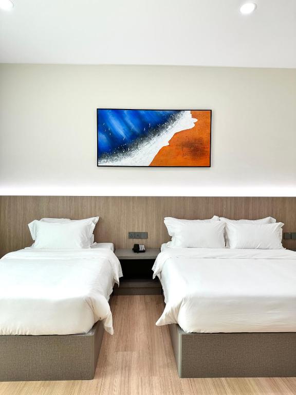 Postel nebo postele na pokoji v ubytování Wendu Inn Hotel