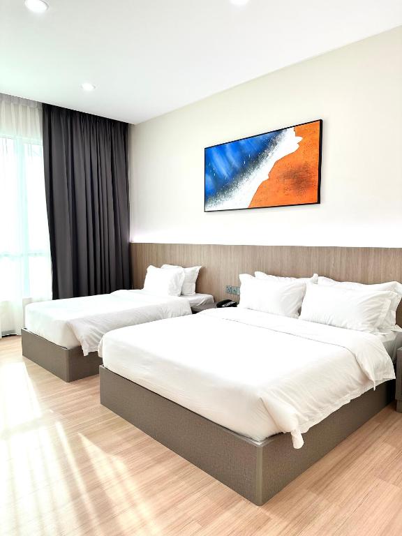 Postel nebo postele na pokoji v ubytování Wendu Inn Hotel