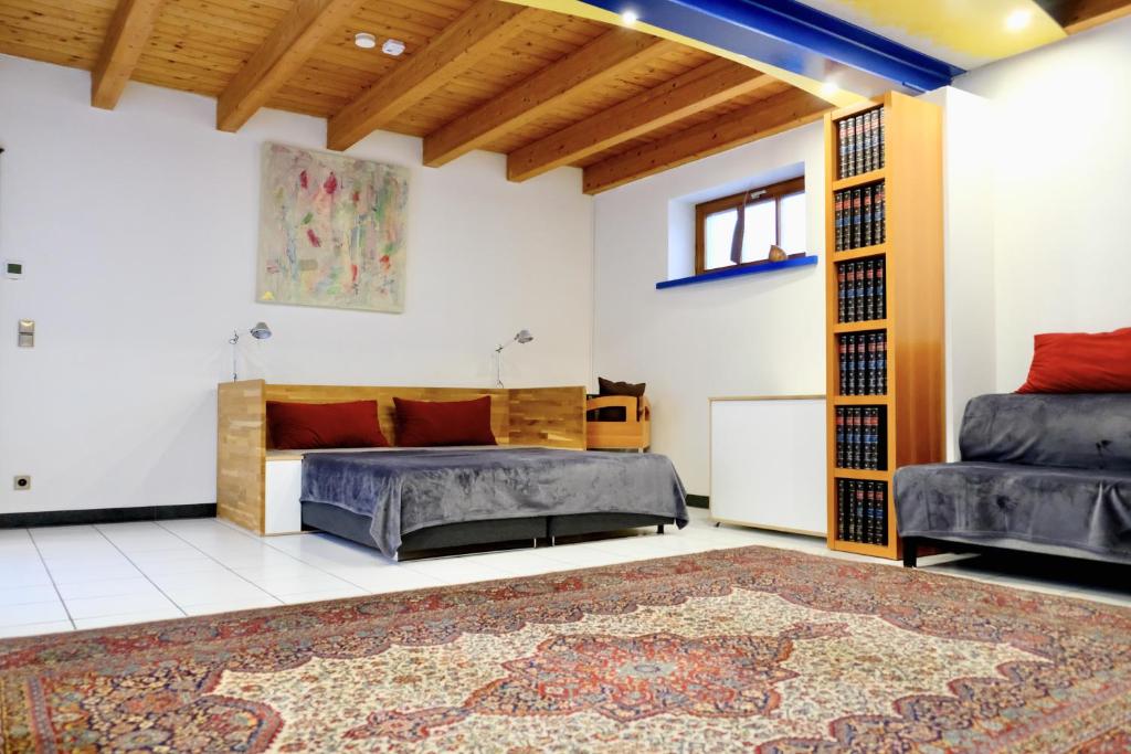 a bedroom with two beds and a rug at Charmantes Fachwerkhaus mit Stil in Altrip