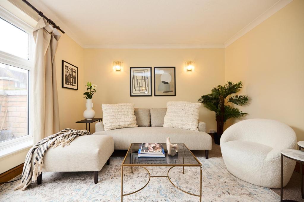 a living room with a couch and a table at The Enfield Place - Elegant 4BDR House with Garden in Winchmore Hill