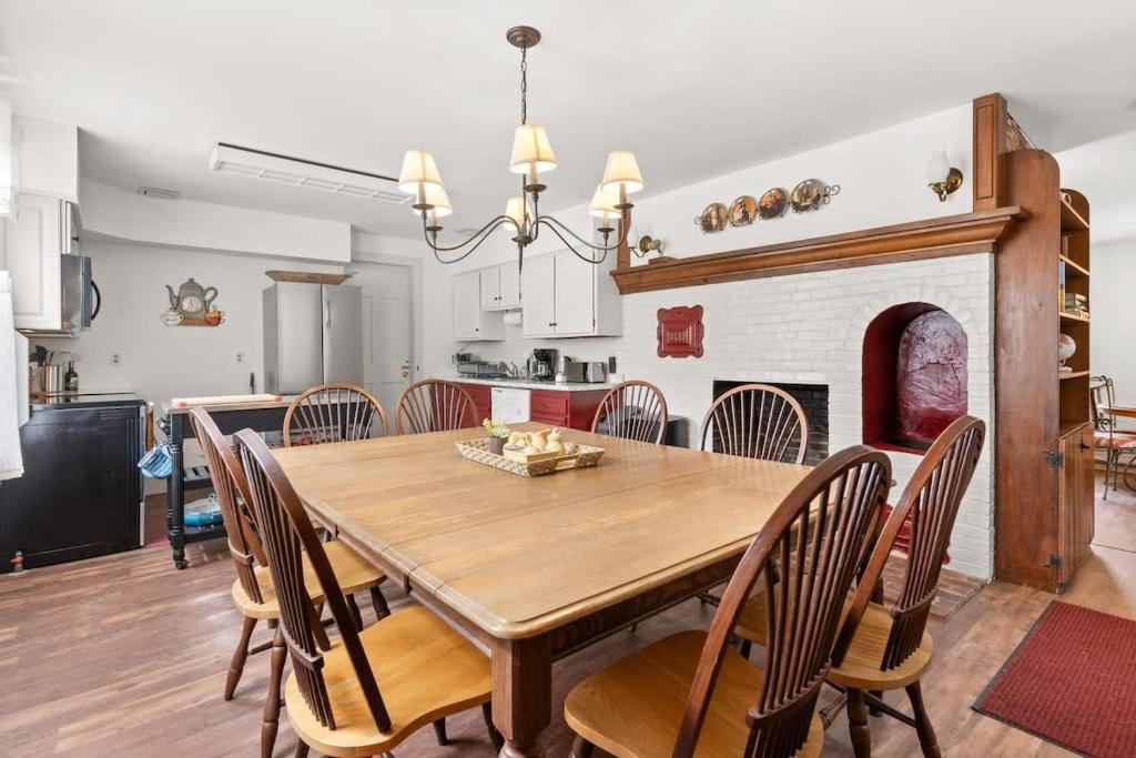 a kitchen and dining room with a wooden table and chairs at Federal on Exeter Circa 1805 Sleeps 8 in Exeter