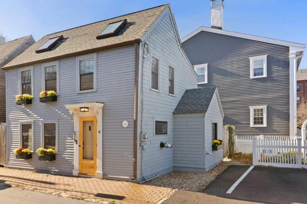 a gray house with a yellow door at Circa 1789 Historic South End Downtown Home in Newburyport