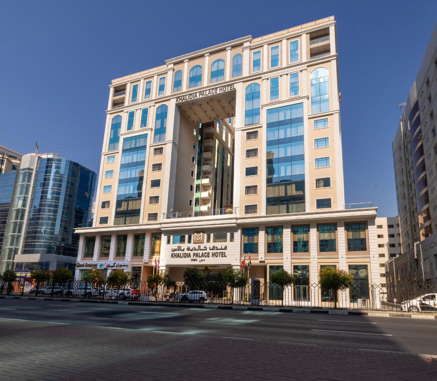 a large building on a street in a city at Khalidia Palace Hotel Dubai in Dubai