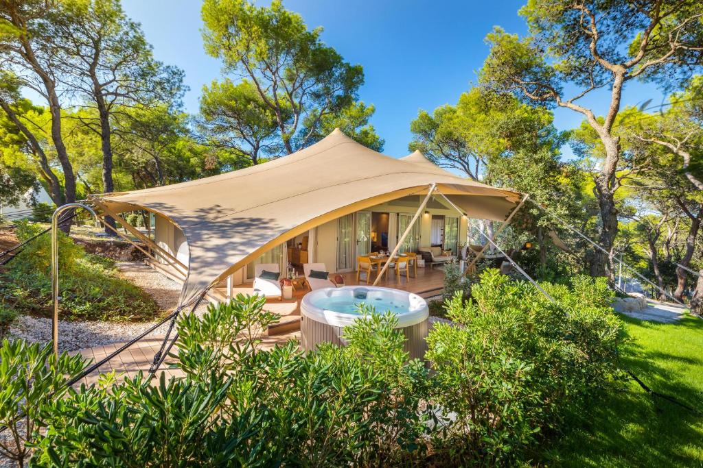 a gazebo in a yard with trees at Arena One 99 Glamping in Pula