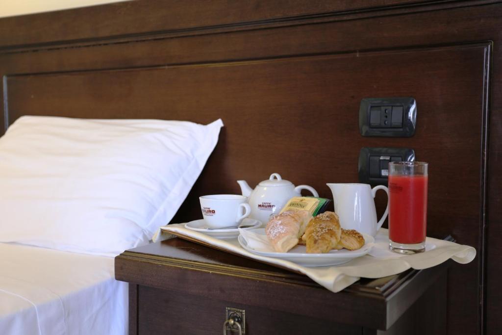 Postel nebo postele na pokoji v ubytování Albanuova Hotel
