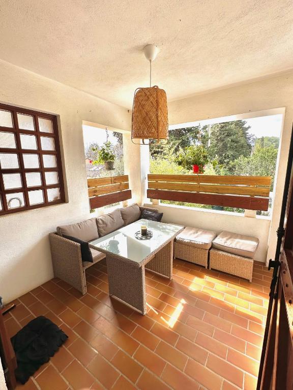 a living room with a couch and a table at Appartement Spacieux proche des Plages de la coudouliere in Six-Fours-les-Plages