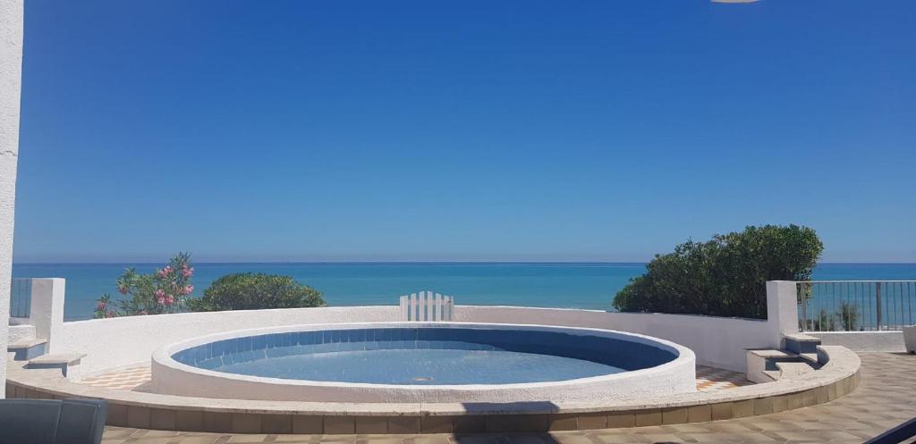 a hot tub on a patio with the ocean in the background at Beach casa sul mare in Termoli