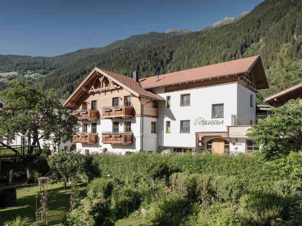 a hotel in the mountains with a garden at MYALPS Mühlhof in Oetz