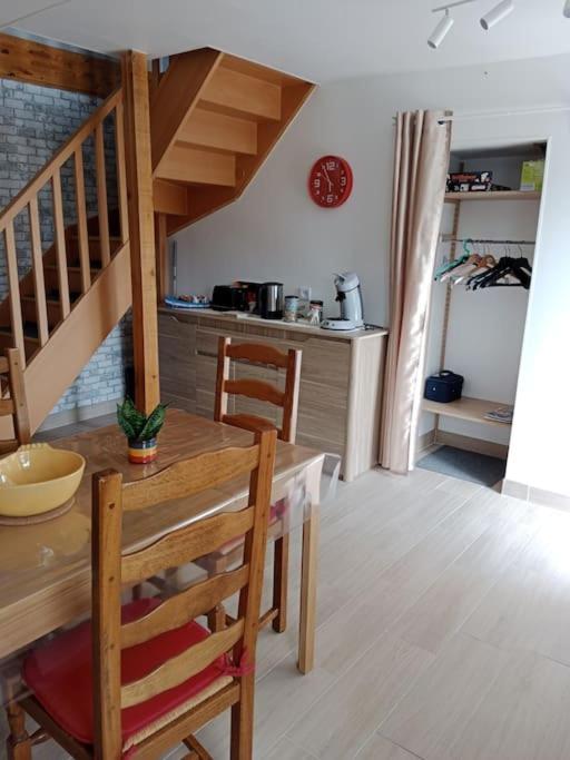 a kitchen with a wooden table and a dining room at maison ancienne in Louviers