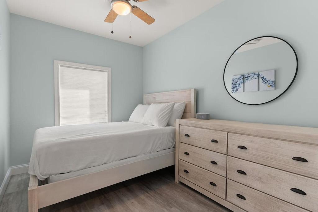 a bedroom with a bed and a mirror and a dresser at Fully Renovated - Sleeps 6 - Walk to Beach in Hampton