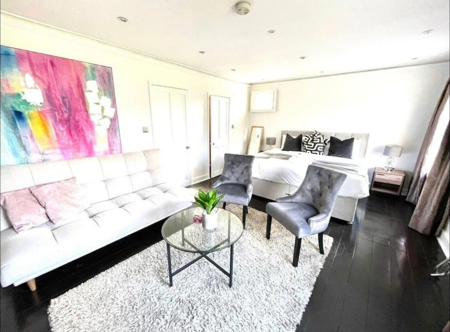 a living room with a white couch and a bed at Historical Police Station Building l Central Cambridge I Park View in Cambridge