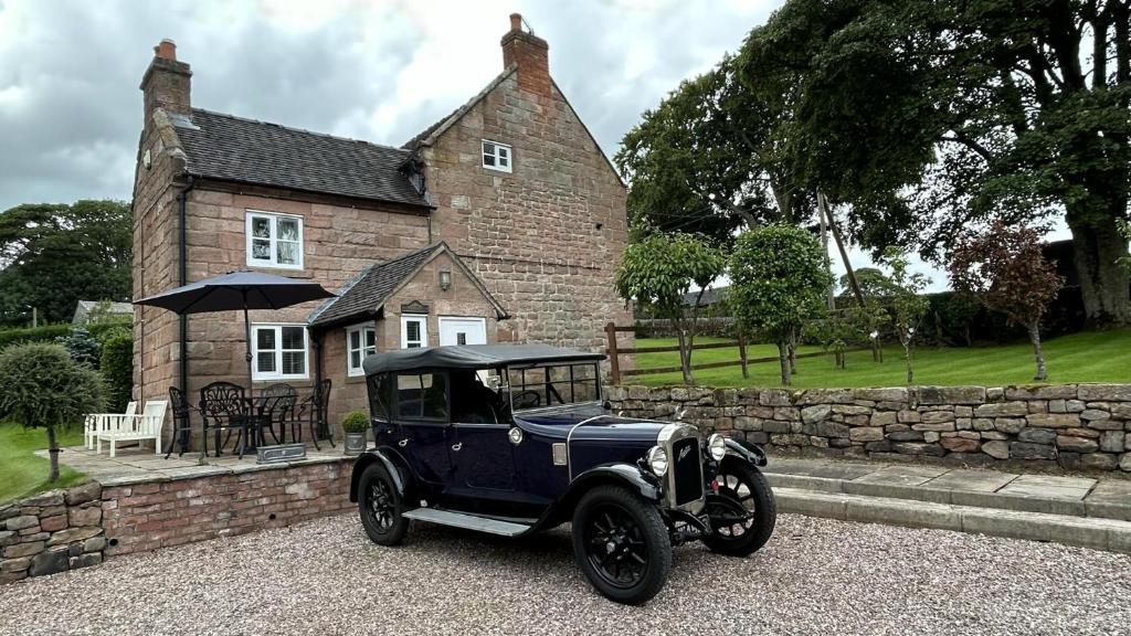 an old blue car parked in front of a house at Character 3-Bed Cottage Alton Towers Polars Peaks in Whiston