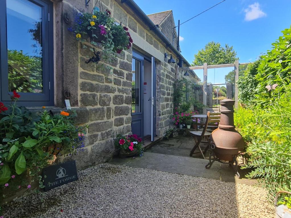 a brick house with a blue door and a window at 1 Bed in Alderwasley 94394 in Alderwasley