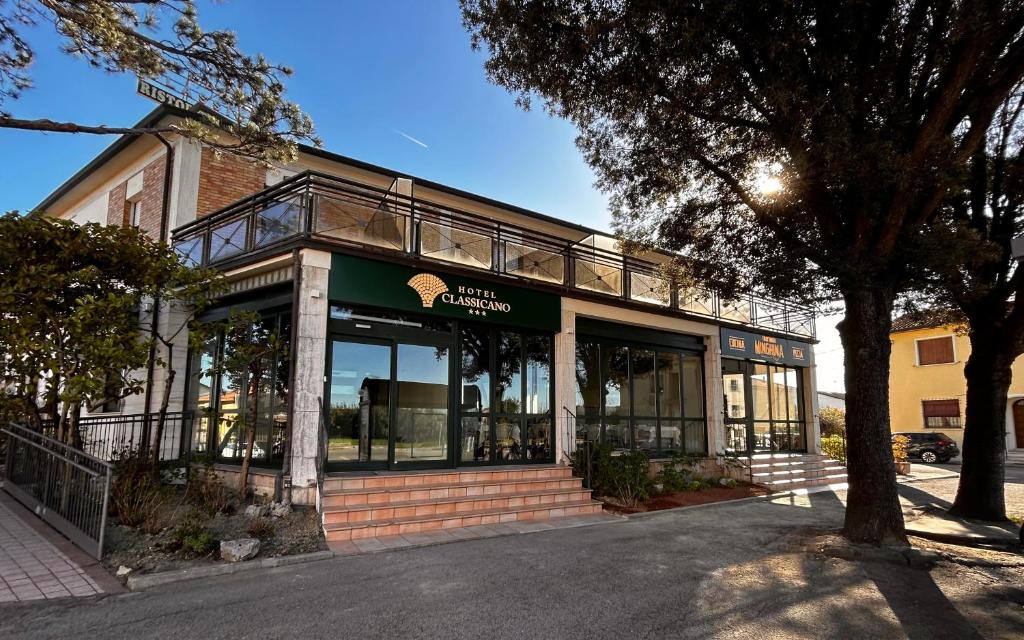 a store front of a building with glass windows at Hotel Classicano in Ravenna