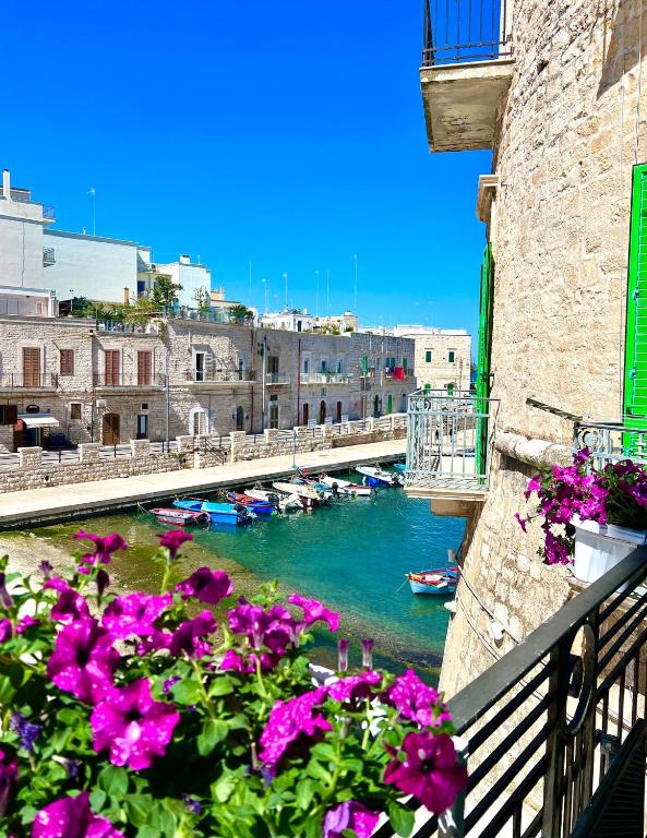 a view of a river from a balcony with flowers at Torrione Apartment in Giovinazzo
