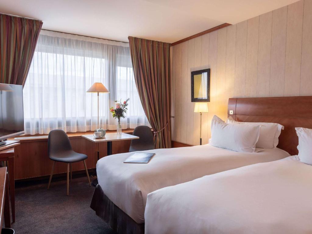 Postel nebo postele na pokoji v ubytování Sofitel Lyon Bellecour