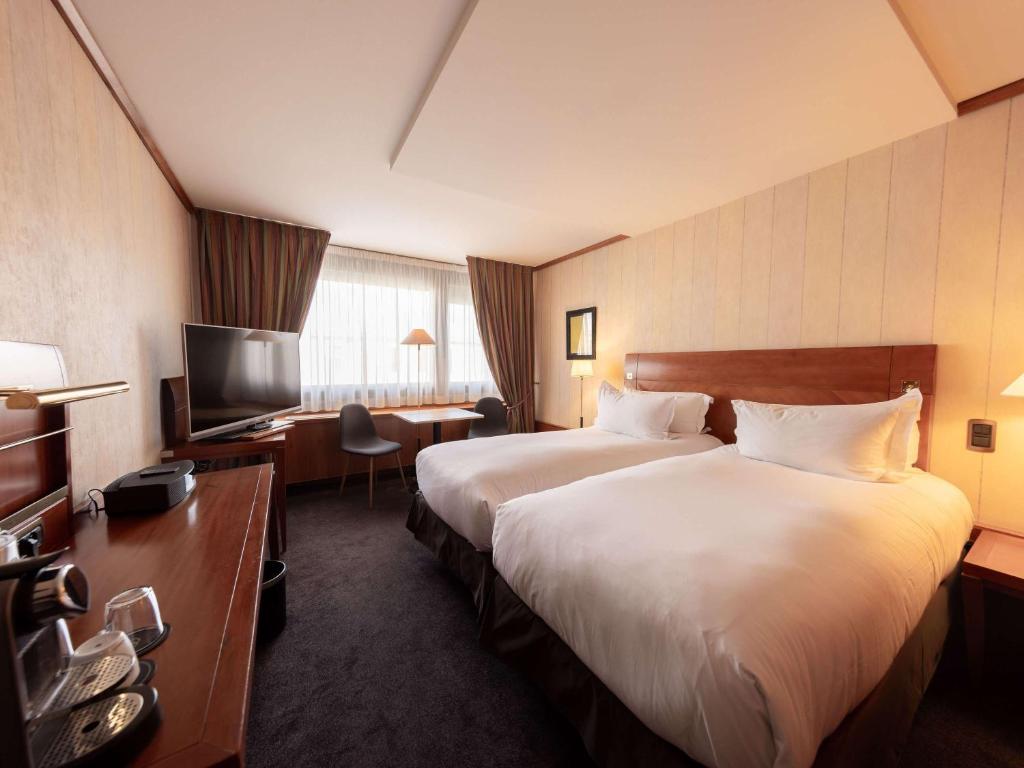 Postel nebo postele na pokoji v ubytování Sofitel Lyon Bellecour