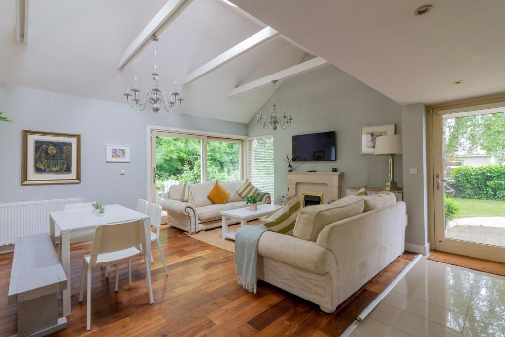 a living room with a couch and a table at GuestReady - Opulence Malahide Seaside Cottage in Malahide