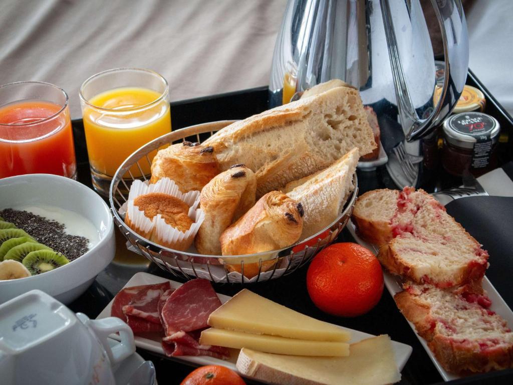 a tray of food with bread and cheese and drinks at Mercure Lyon Centre Beaux-Arts in Lyon