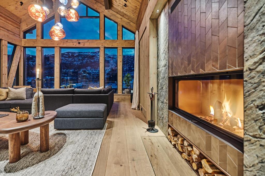 a living room with a fireplace in a house at Chalet Strandafjellet in Stranda