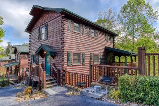 a log cabin with a wooden fence in front of it at Dreams Come True With This Luxury Cabin! in Gatlinburg