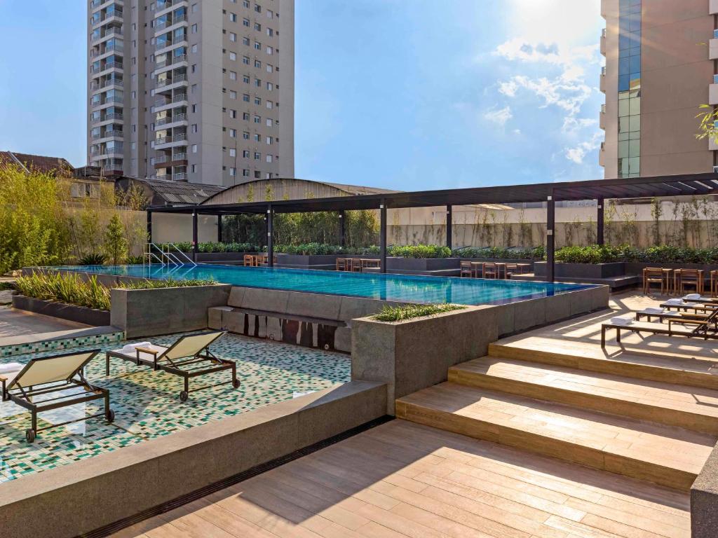 a swimming pool on the roof of a building at Mercure Sao Paulo Barra Funda in Sao Paulo