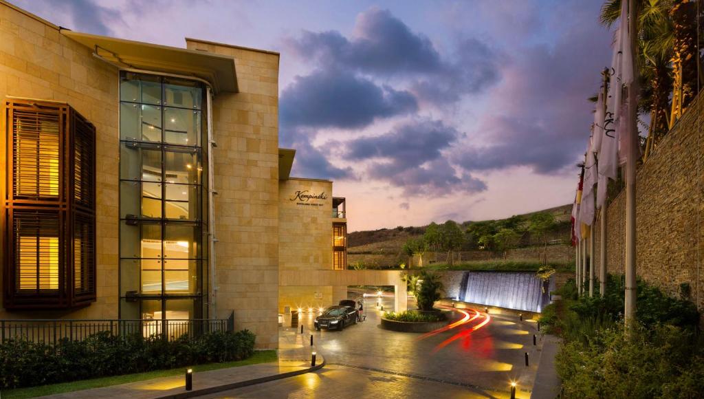 a building with a car parked in a parking lot at Kempinski Summerland Hotel & Resort Beirut in Beirut