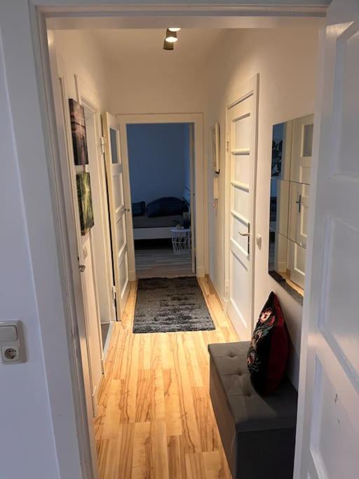 un couloir menant à un salon avec un canapé dans l'établissement Tolles Appartement, zentrumsnahe 2 Schlafzimmer, à Lübeck