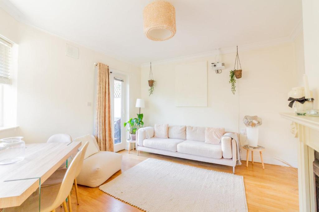 a living room with a white couch and a table at GuestReady - Tranquil retreat in Chapelizod in Dublin