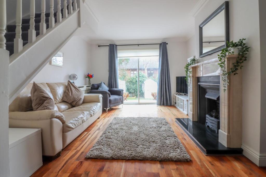 a living room with a couch and a fireplace at GuestReady - Coastal Charm near Sandymount Beach in Dublin