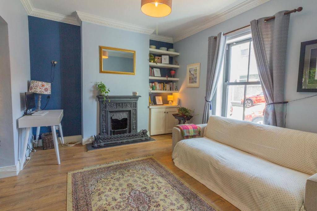 a living room with a couch and a fireplace at GuestReady - Charming House in East Wall in Dublin