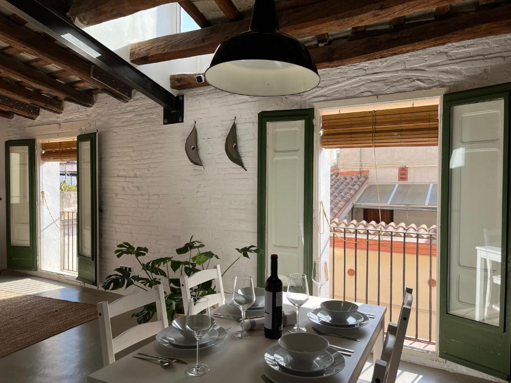 a dining room with a table with a bottle of wine at Centric apartment in Vilanova i la Geltru in Vilanova i la Geltrú