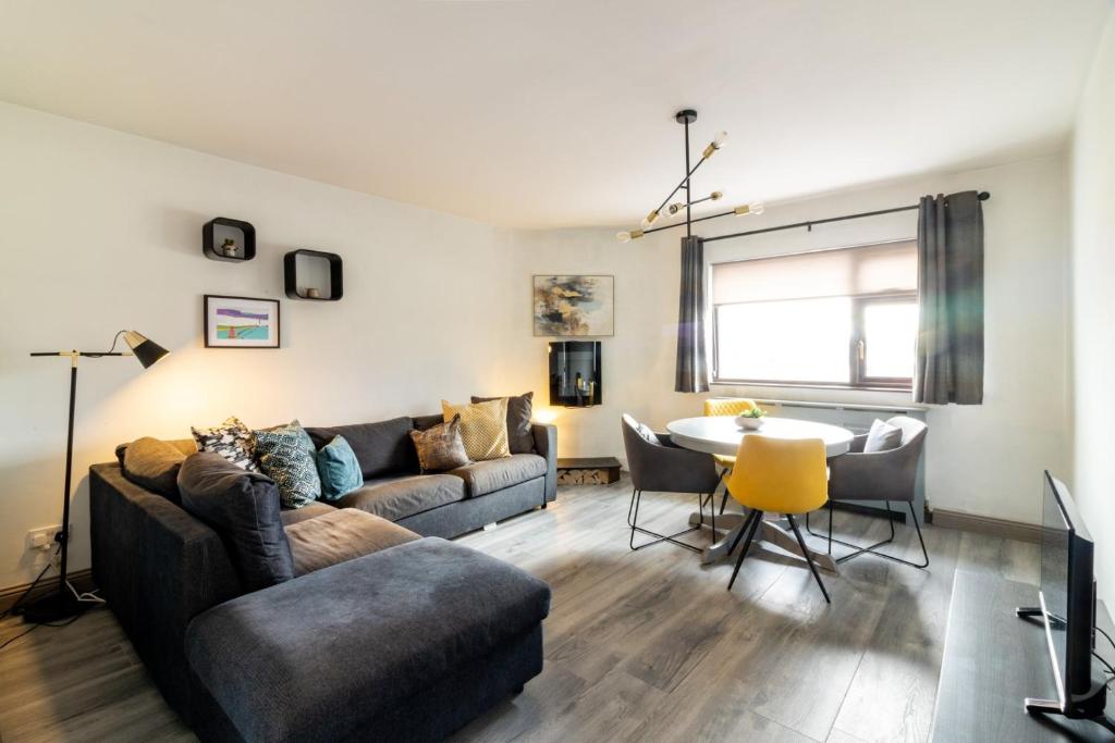 a living room with a couch and a table at GuestReady - Marvellous home in Seabury in Dublin