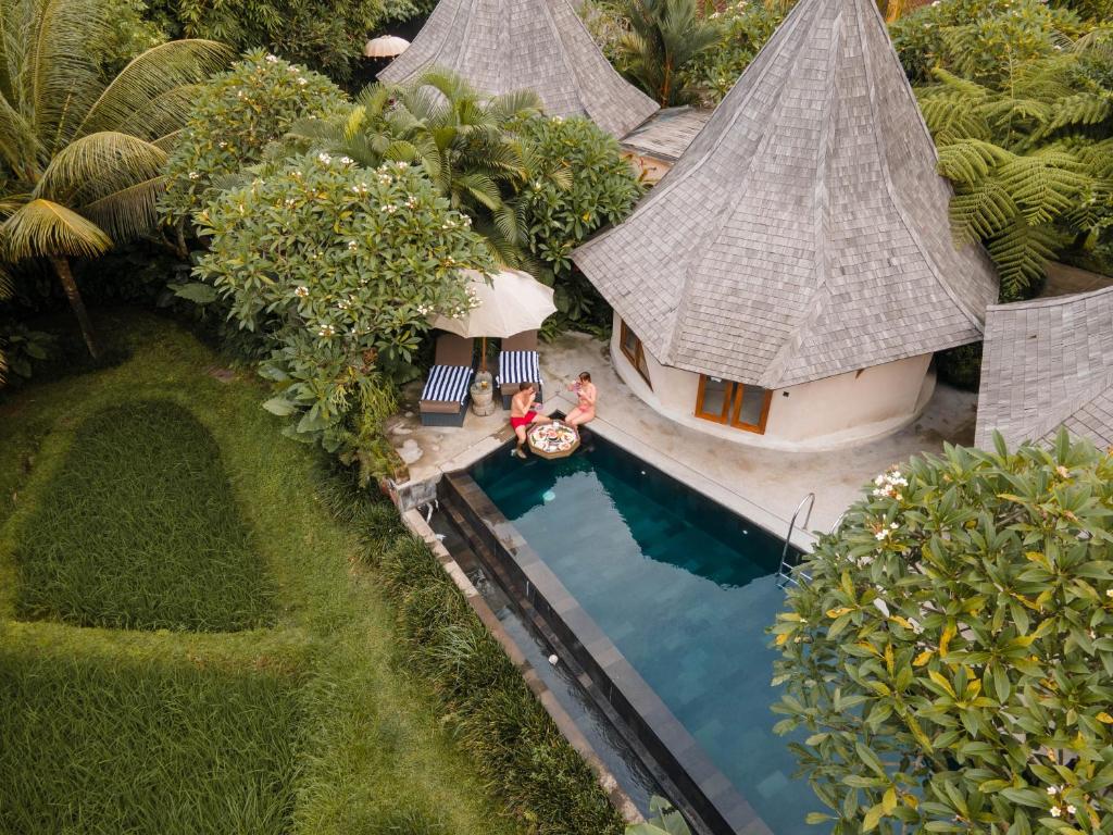 an aerial view of a house with a swimming pool at The Sender Pool Suites in Ubud