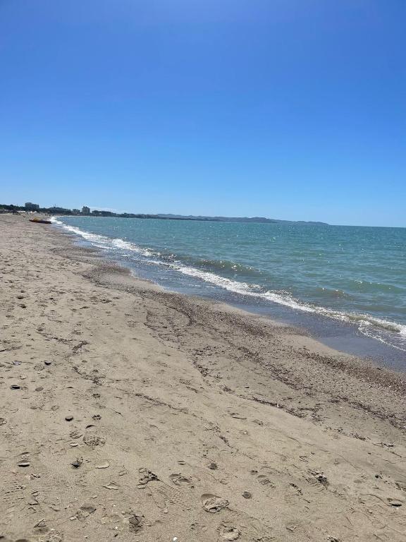 an empty beach with the ocean in the background at Beach Home Retreat in Durrës