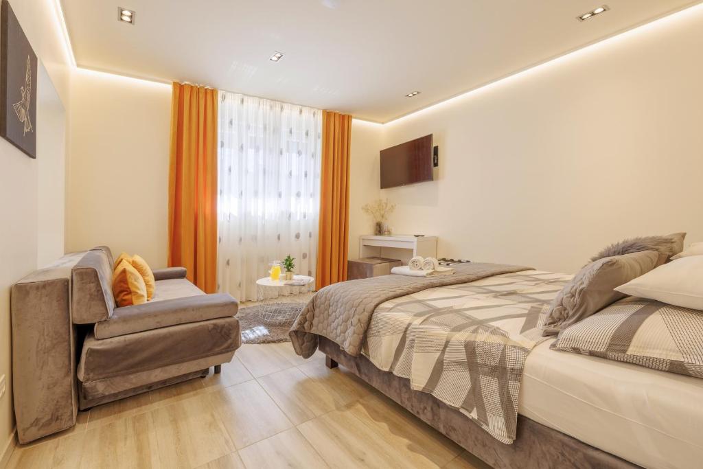 a bedroom with a bed and a chair at Perimar Luxury Apartments and Rooms Split Center in Split