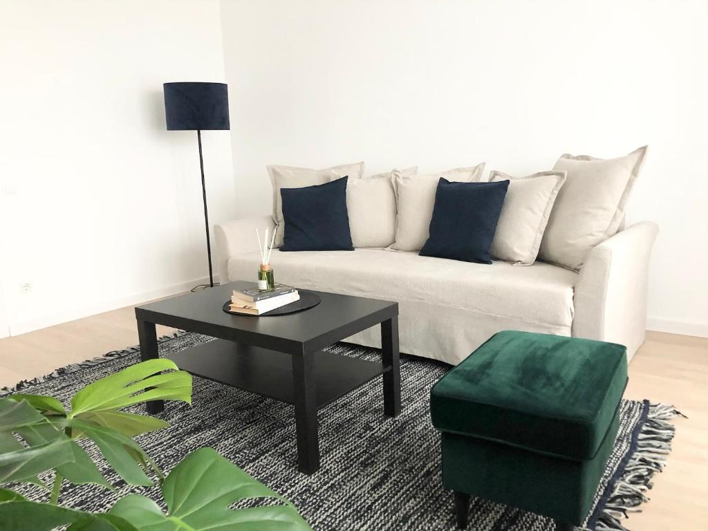 a living room with a couch and a coffee table at Modernūs apartamentai Šilutėje in Šilutė