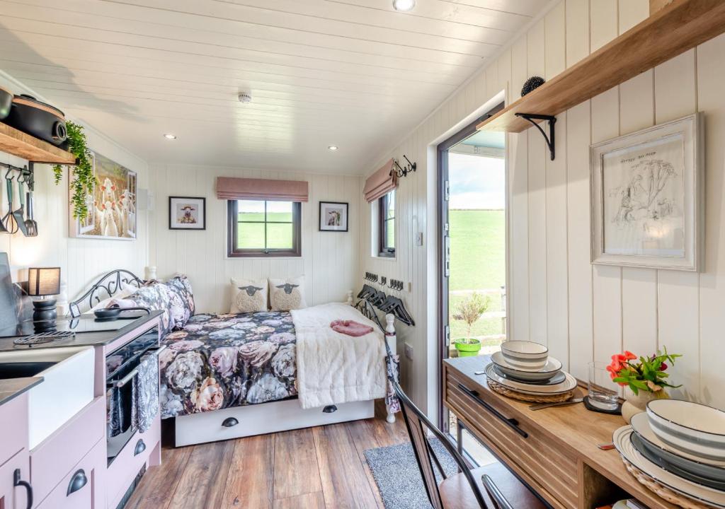 a bedroom in a tiny house with a bed at Little Bo Peep in Fremington