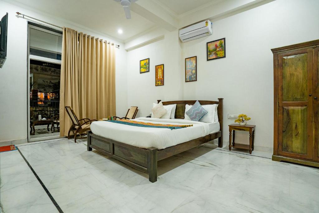 a bedroom with a bed in a room at Tripli Hotels GADH BANSIYA in Udaipur